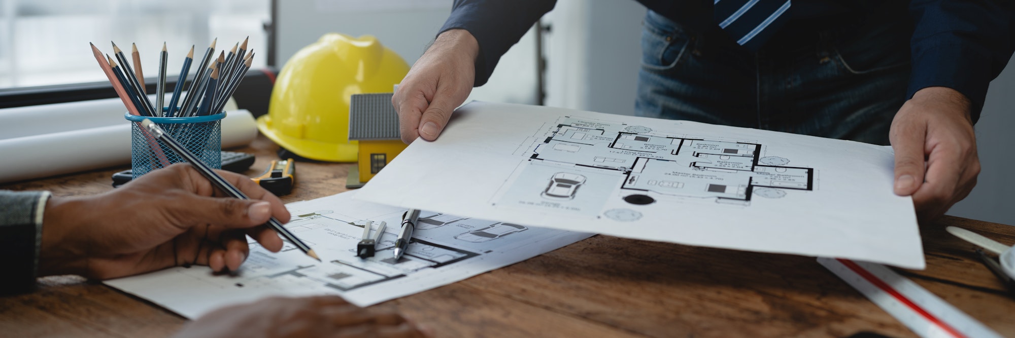 Structural engineer team discussing and calculating work Office design of the building structure con